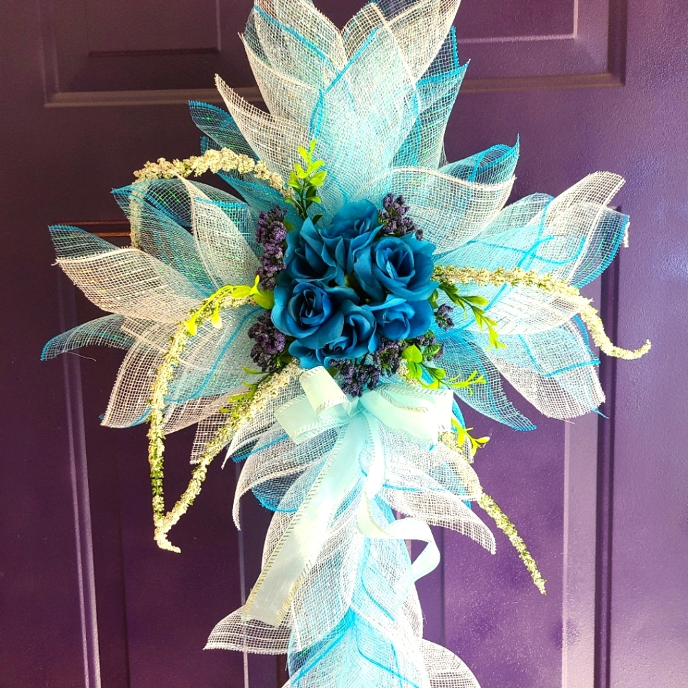 Blue and white  cross wreath with coordinating flowers, bows and ribbons.
